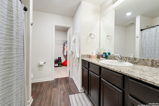 bathroom featuring hardwood / wood-style flooring, vanity, and toilet