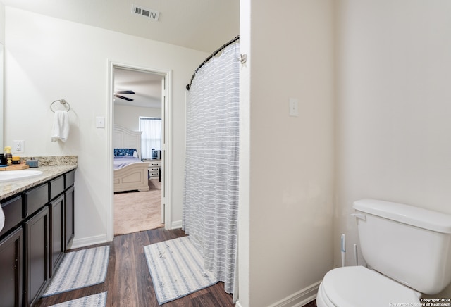 bathroom with ceiling fan, toilet, hardwood / wood-style floors, and vanity