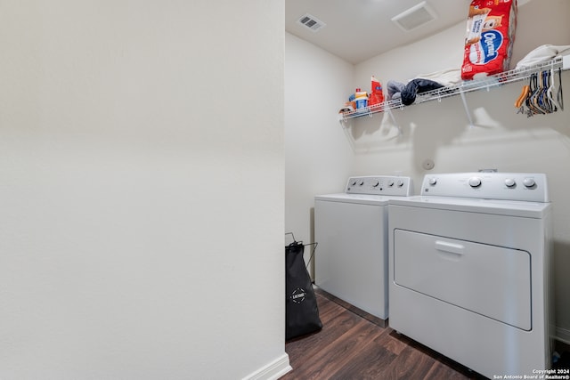 laundry room featuring dark wood-type flooring and washer and dryer