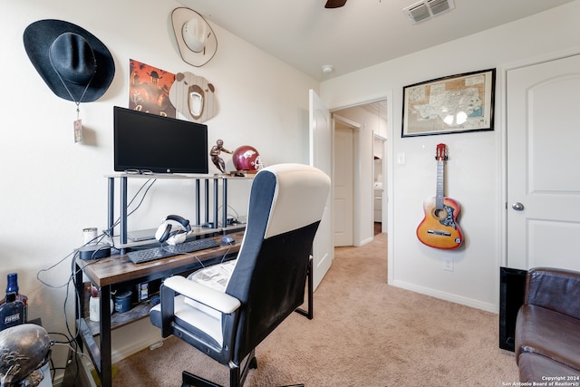 carpeted office space featuring ceiling fan