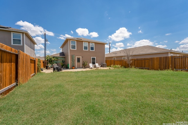 rear view of property featuring a patio area and a lawn