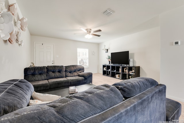 living room featuring ceiling fan and light carpet