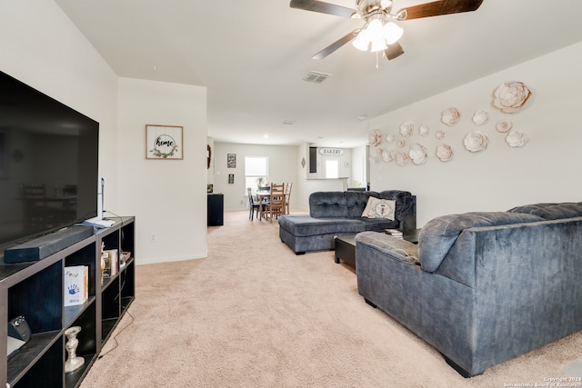 living room with ceiling fan and light carpet