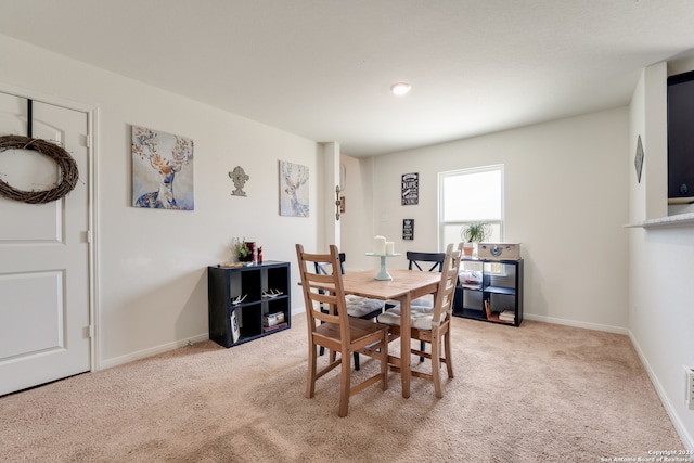 dining space with light colored carpet