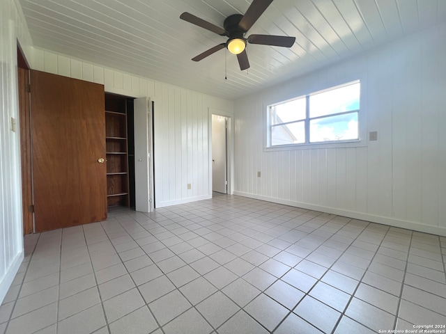 unfurnished bedroom featuring a closet, ceiling fan, and light tile patterned floors