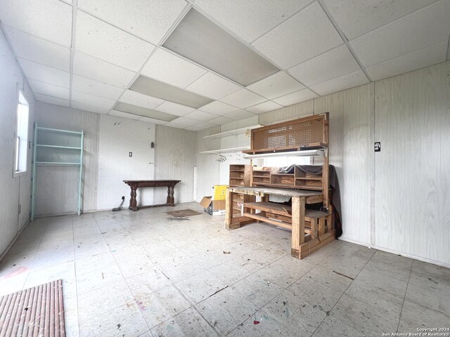 unfurnished bedroom featuring a drop ceiling and tile patterned floors