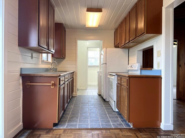 kitchen featuring dark parquet floors, sink, and white electric range