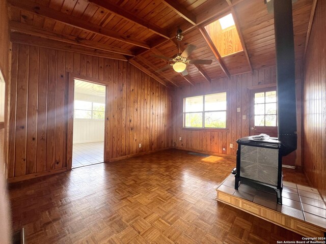 interior space with wood ceiling, light parquet flooring, and wood walls