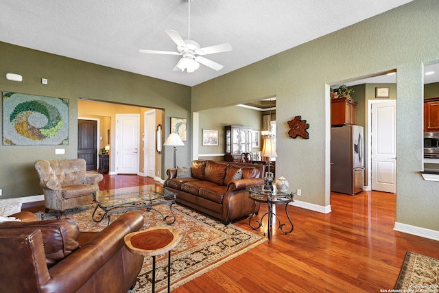 living room featuring hardwood / wood-style flooring and ceiling fan