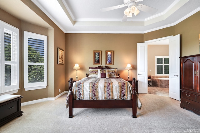 carpeted bedroom featuring ceiling fan, a raised ceiling, and ornamental molding