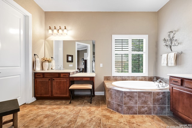 bathroom featuring tiled bath, tile patterned flooring, and vanity