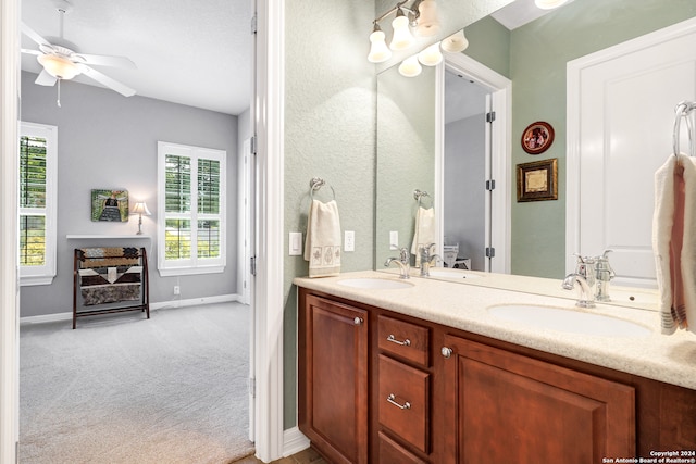 bathroom with ceiling fan and double sink vanity