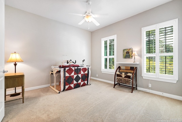 interior space with ceiling fan and light carpet