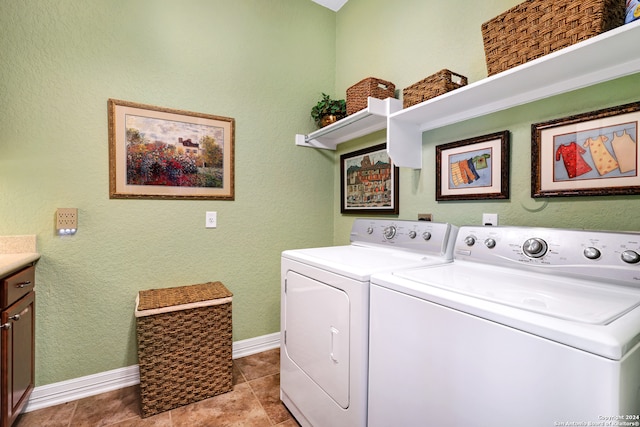 laundry area featuring light tile patterned floors, washing machine and dryer, and cabinets