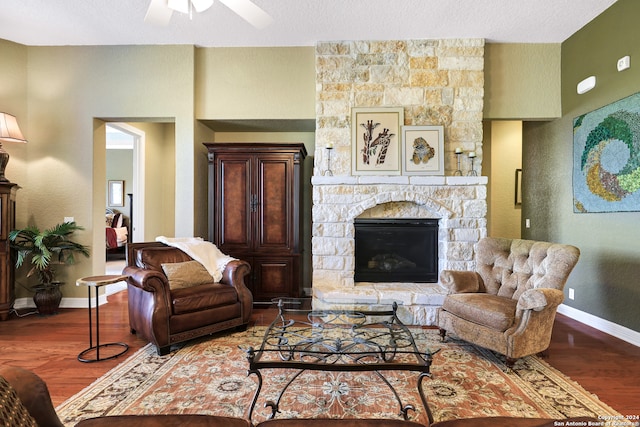 living room featuring ceiling fan, a textured ceiling, and hardwood / wood-style floors