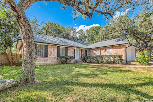 ranch-style home with a front lawn