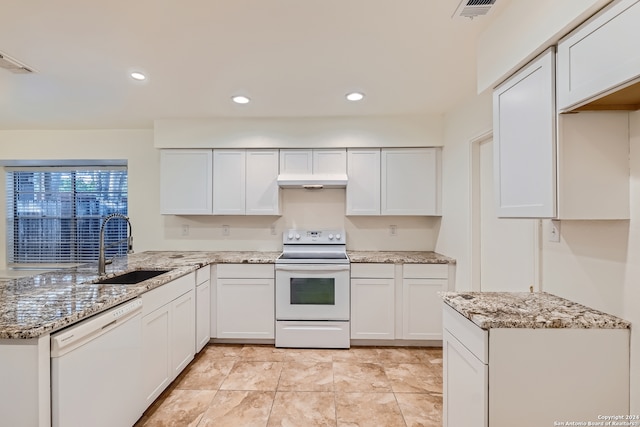 kitchen featuring white cabinets, sink, light tile patterned flooring, and white appliances