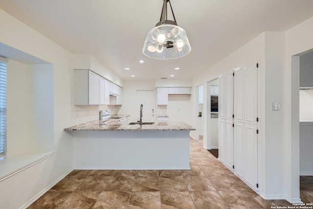 kitchen with light stone counters, light tile patterned floors, sink, white range with electric cooktop, and kitchen peninsula