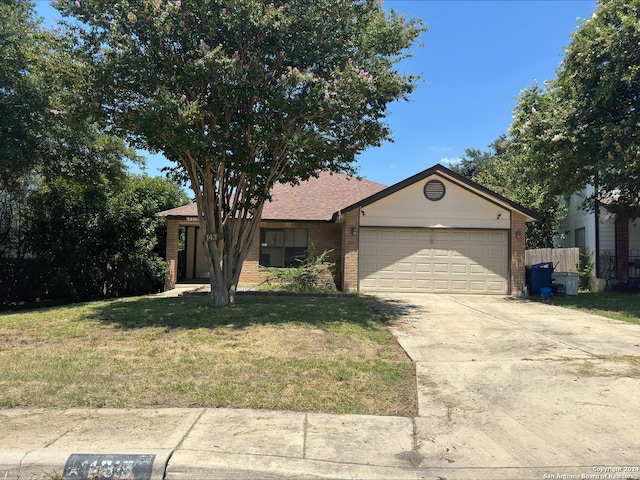 ranch-style home with a garage and a front yard