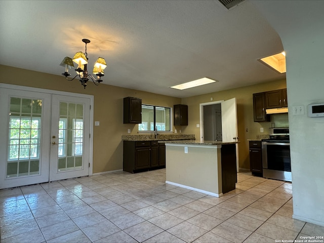 kitchen with stainless steel range with electric stovetop, french doors, dark brown cabinetry, a notable chandelier, and light tile patterned flooring