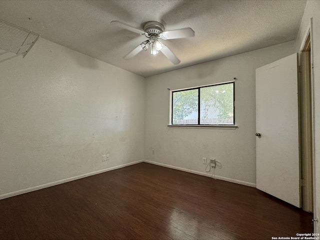 interior space featuring ceiling fan, a textured ceiling, and dark hardwood / wood-style floors