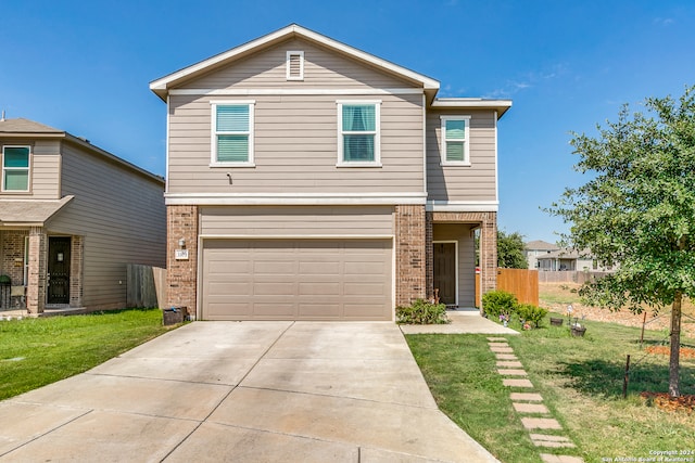 view of front property featuring a garage and a front lawn