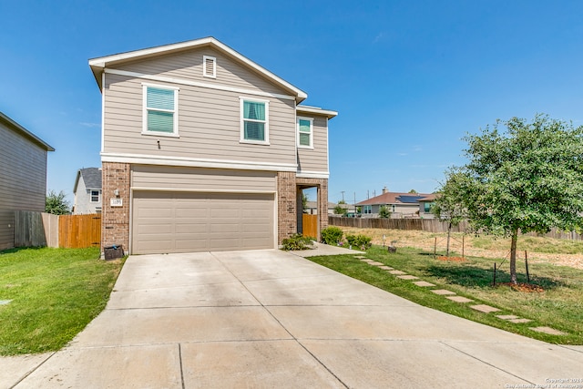 view of front of property with a garage and a front yard