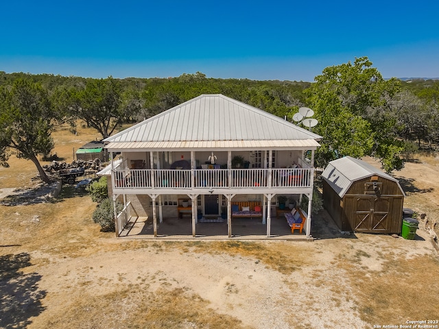 exterior space with a storage shed and a patio area