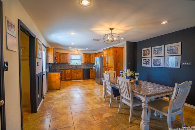 tiled dining area with sink and a chandelier