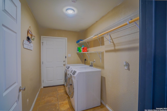 clothes washing area with light tile patterned floors and independent washer and dryer