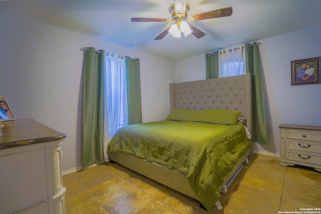 tiled bedroom featuring ceiling fan