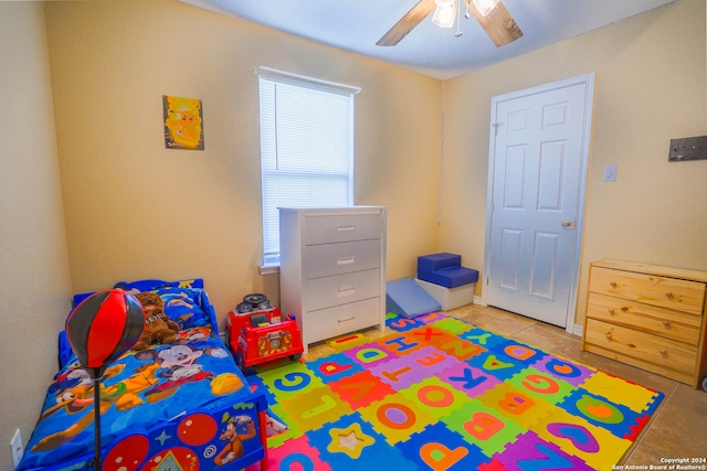 tiled bedroom with ceiling fan