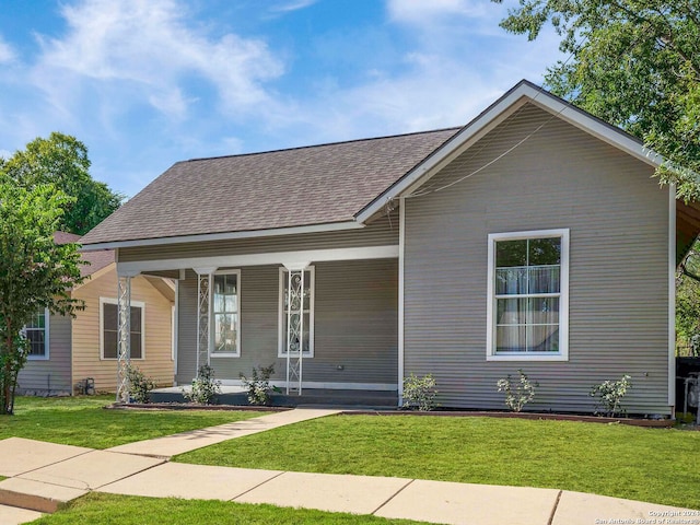 view of front of property with a porch and a front lawn