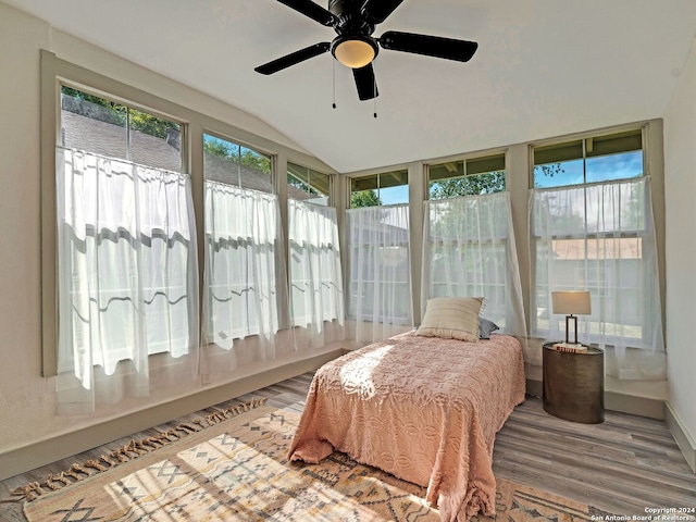 sunroom / solarium with ceiling fan and lofted ceiling