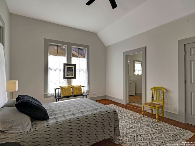 bedroom featuring hardwood / wood-style floors, multiple windows, and ensuite bath