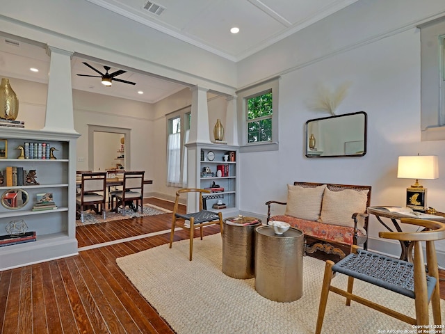 sitting room with ceiling fan, hardwood / wood-style floors, ornamental molding, and decorative columns