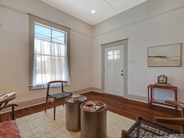 entrance foyer featuring ornamental molding and wood-type flooring