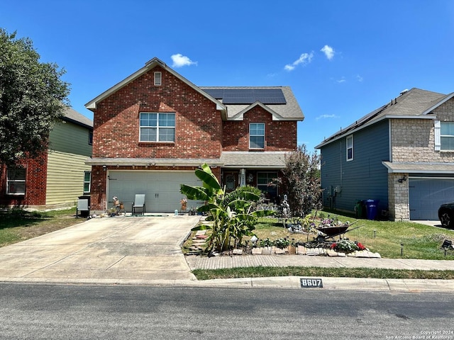 view of front of house featuring solar panels and a garage