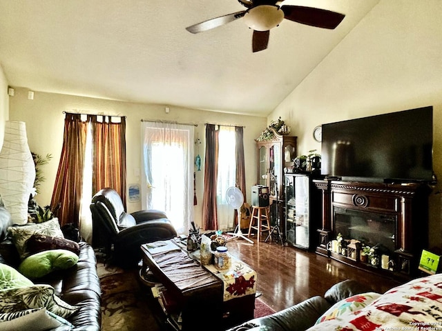 living room with hardwood / wood-style floors, high vaulted ceiling, and ceiling fan