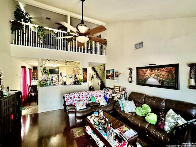 living room with ceiling fan, high vaulted ceiling, and wood-type flooring