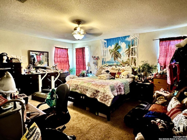 carpeted bedroom featuring ceiling fan and a textured ceiling