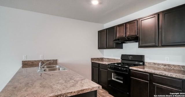 kitchen featuring sink, dark brown cabinets, and black range with gas stovetop