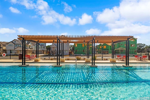 view of swimming pool with a pergola