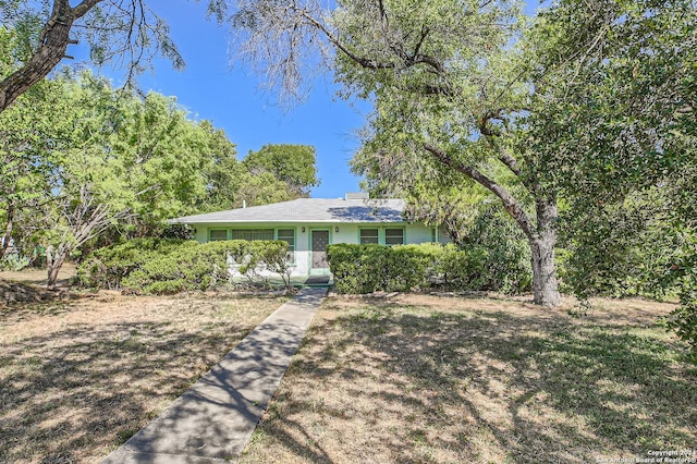ranch-style house with a front lawn