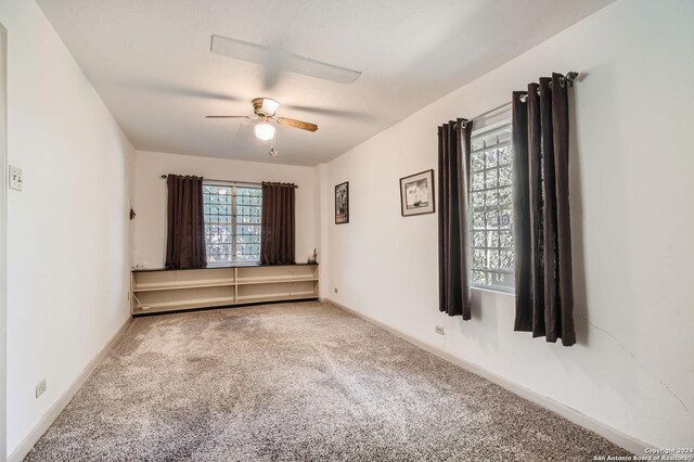 unfurnished room featuring carpet floors and ceiling fan