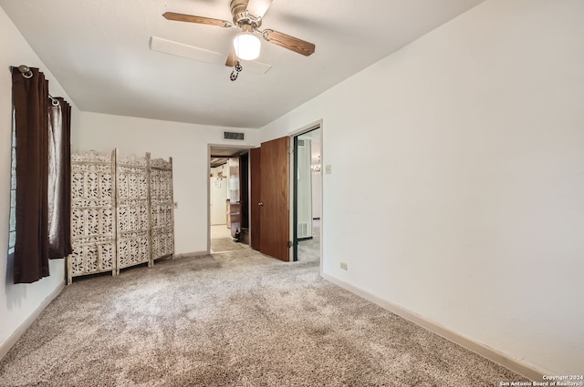 carpeted empty room featuring ceiling fan