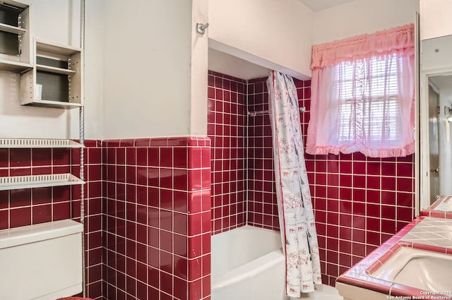 bathroom with toilet, shower / bathtub combination with curtain, and tile walls