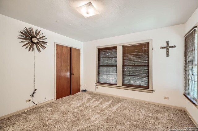 unfurnished bedroom featuring a closet and carpet