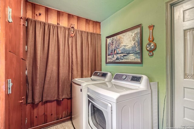 clothes washing area featuring separate washer and dryer