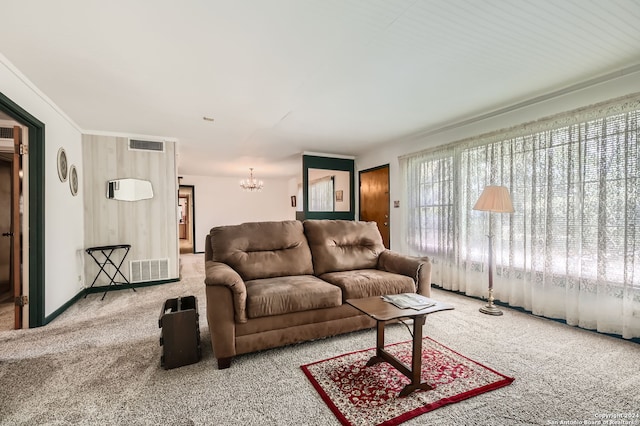 living room featuring carpet, a notable chandelier, and ornamental molding